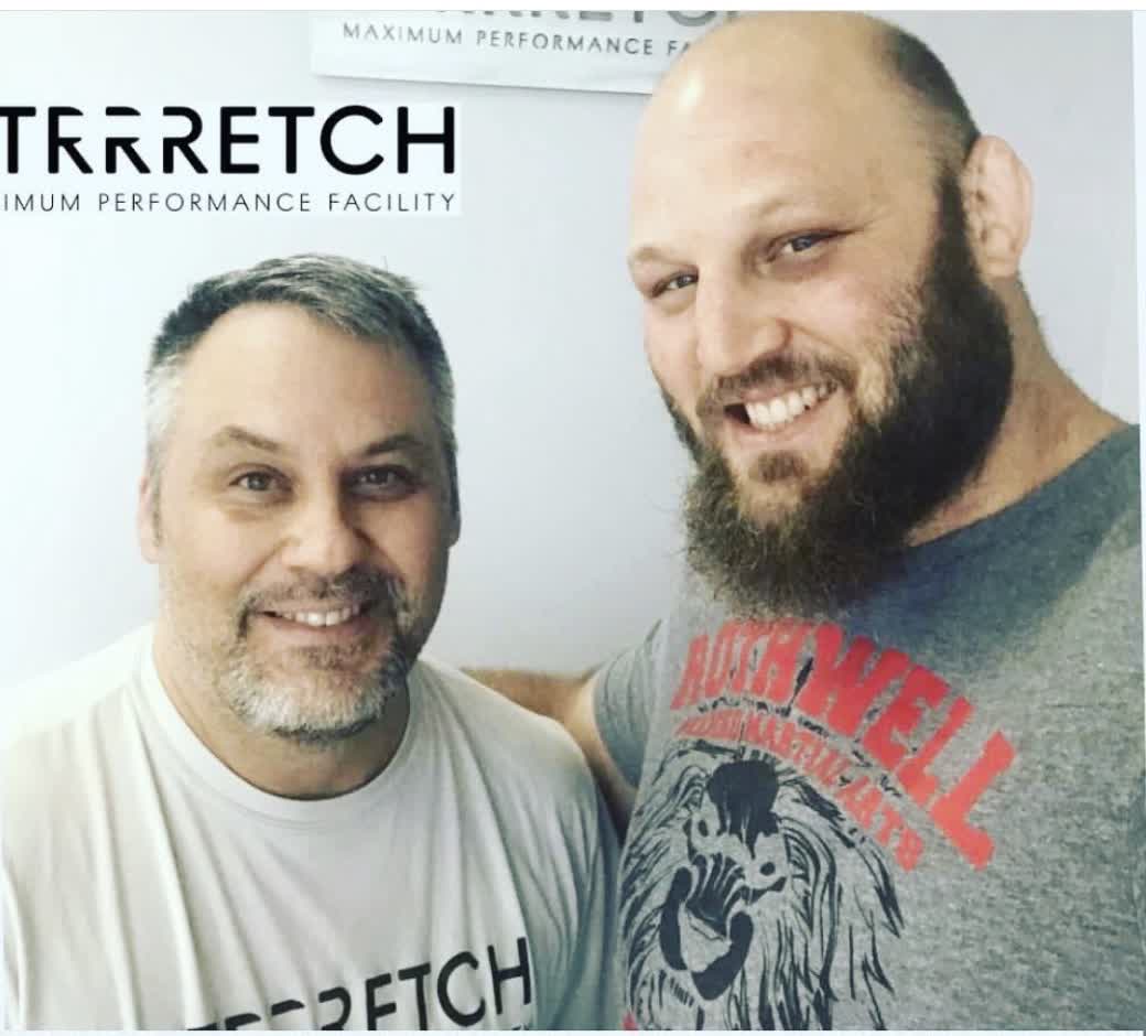 Ben Rothwell with a Strrretch practitioner in front of a Strrretch sign